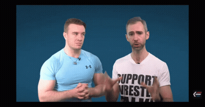 Two Men Are Standing Next To Each Other And One Of Them Is Wearing A Shirt That Says Support Wrestling GIF