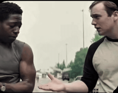 Two Men Are Standing Next To Each Other And One Of Them Is Wearing A Shirt With The Letter H On It GIF