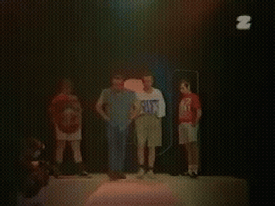 Two Men Are Standing Next To Each Other And One Of Them Is Wearing A White Shirt With The Letter Z On It . GIF