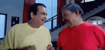 Two Men Are Standing Next To Each Other And Talking In A Living Room . GIF