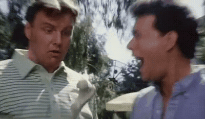 Two Men Are Standing Next To Each Other And Talking . GIF