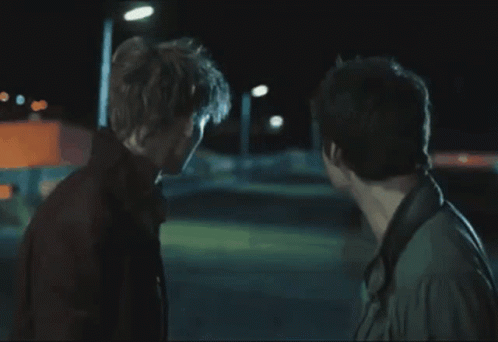 Two Men Are Standing Next To Each Other And Talking GIF