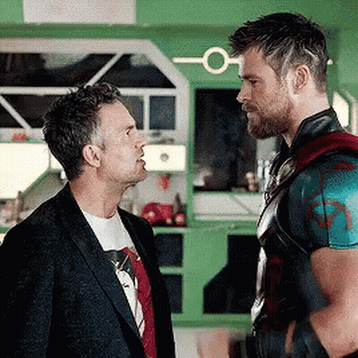 Two Men Are Standing Next To Each Other And Talking To Each Other In A Kitchen . GIF