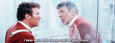 Two Men Are Standing Next To Each Other And Talking To Each Other . GIF