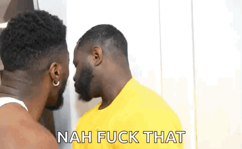Two Men Are Standing Next To Each Other And Talking To Each Other . One Of The Men Is Wearing A Yellow Shirt . GIF