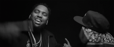 Two Men Are Standing Next To Each Other In A Black And White Photo . One Of The Men Is Wearing A Bandana . GIF