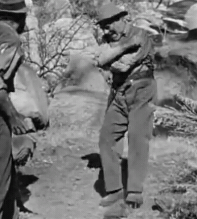 Two Men Are Standing Next To Each Other In A Black And White Photo . GIF
