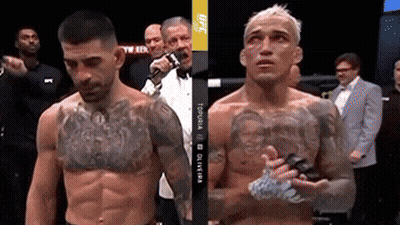 Two Men Are Standing Next To Each Other In A Boxing Ring And One Of Them Has A Tattoo On His Chest .. GIF