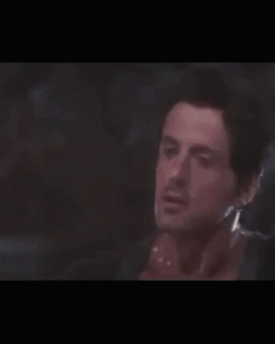 Two Men Are Standing Next To Each Other In A Boxing Ring . GIF
