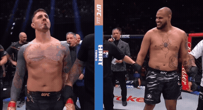 Two Men Are Standing Next To Each Other In A Boxing Ring With A Banner That Says Ufc On It GIF
