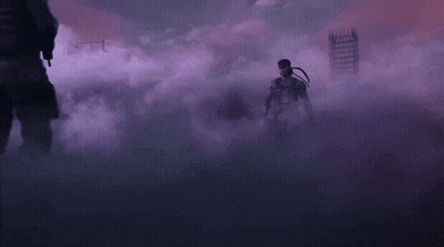 Two Men Are Standing Next To Each Other In A Dark Room Surrounded By Smoke . GIF