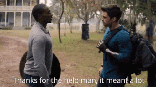 Two Men Are Standing Next To Each Other In A Field And Talking To Each Other . GIF