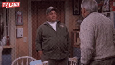 Two Men Are Standing Next To Each Other In A Kitchen . GIF