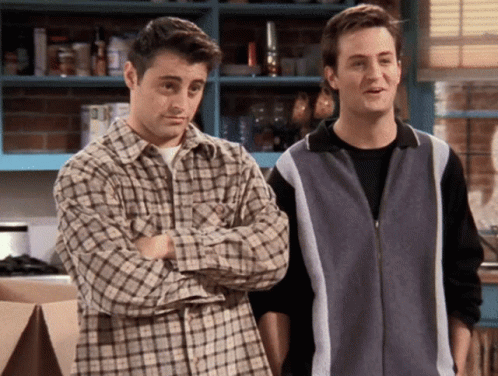 Two Men Are Standing Next To Each Other In A Kitchen With Their Arms Crossed GIF