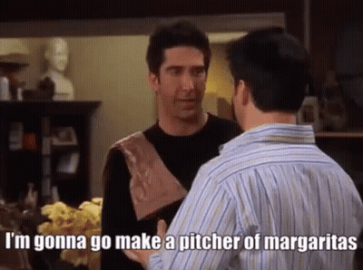 Two Men Are Standing Next To Each Other In A Living Room Talking . GIF