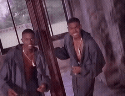 Two Men Are Standing Next To Each Other In A Room GIF