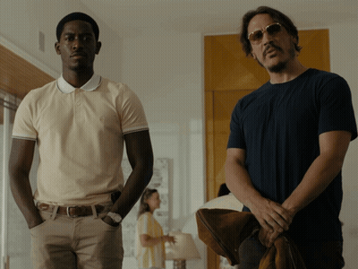 Two Men Are Standing Next To Each Other In A Room GIF