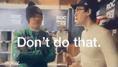 Two Men Are Standing Next To Each Other In A Room And One Of Them Is Talking To The Other . GIF