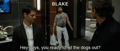 Two Men Are Standing Next To Each Other In A Room And One Of Them Is Talking To The Other About Letting The Dogs Out . GIF
