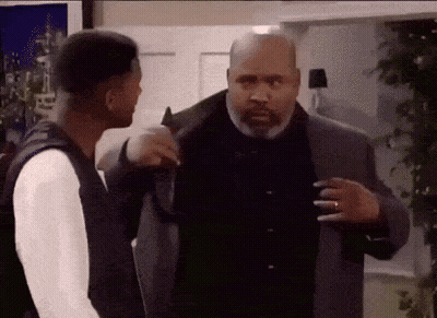 Two Men Are Standing Next To Each Other In A Room And Talking To Each Other . GIF