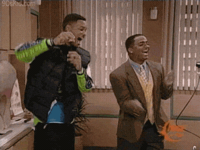 Two Men Are Standing Next To Each Other In A Room Dancing . GIF