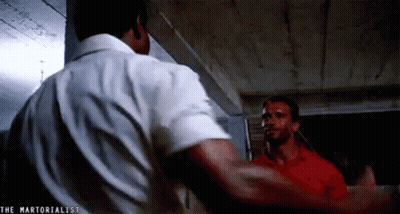 Two Men Are Standing Next To Each Other In A Room . GIF