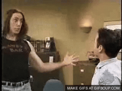 Two Men Are Standing Next To Each Other In A Room . GIF