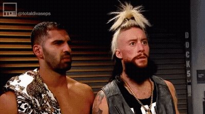 Two Men Are Standing Next To Each Other In A Room . One Of The Men Has A Ponytail On His Head . GIF