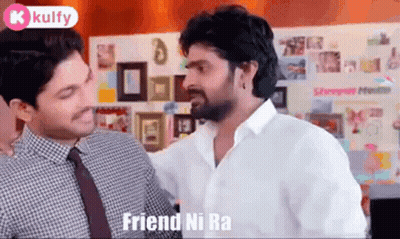 Two Men Are Standing Next To Each Other In A Room Talking To Each Other . GIF