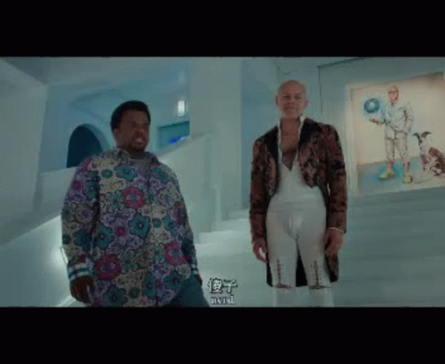 Two Men Are Standing Next To Each Other In A Room With Chinese Characters On The Wall . GIF