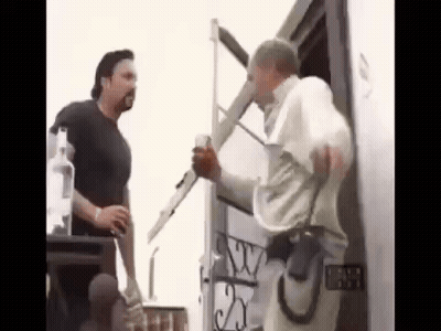 Two Men Are Standing Next To Each Other In Front Of A Building . One Of The Men Is Holding A Ladder . GIF
