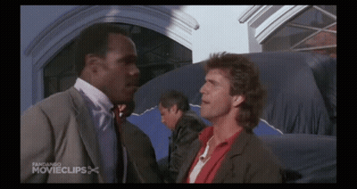 Two Men Are Standing Next To Each Other In Front Of A Building With The Words Fandango Movieclips On The Bottom GIF