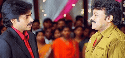 Two Men Are Standing Next To Each Other In Front Of A Crowd And Talking To Each Other . GIF