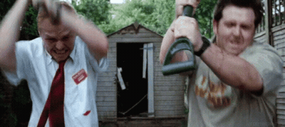Two Men Are Standing Next To Each Other In Front Of A Shed Holding Dumbbells In Their Hands . GIF