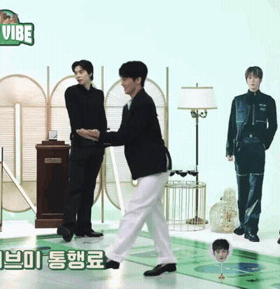 Two Men Are Standing Next To Each Other In Front Of A Sign That Says Vibe On It GIF