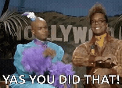 Two Men Are Standing Next To Each Other In Front Of A Sign That Says Yas You Did That GIF