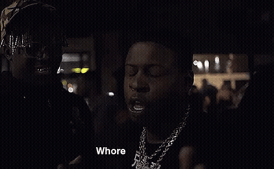 Two Men Are Standing Next To Each Other In The Dark . GIF