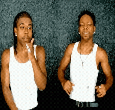 Two Men Are Standing Next To Each Other In White Tank Tops GIF