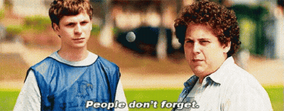 Two Men Are Standing Next To Each Other On A Field And One Of Them Is Saying People Don 'T Forget . GIF