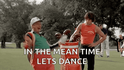 Two Men Are Standing Next To Each Other On A Golf Course Holding Golf Clubs And A Golf Bag . GIF