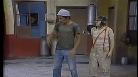 Two Men Are Standing Next To Each Other On A Sidewalk In A Room . GIF