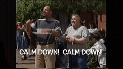 Two Men Are Standing Next To Each Other On A Street In Front Of A Crowd Of People . GIF