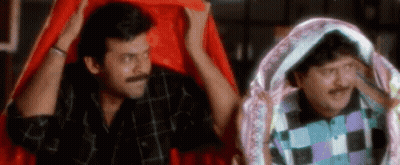Two Men Are Standing Next To Each Other Under A Red Cloth . GIF