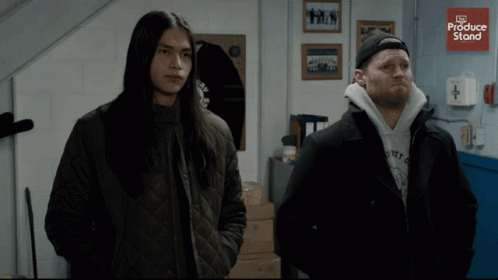 Two Men Are Standing Next To Each Other With A Sign That Says Produce Store In The Background GIF