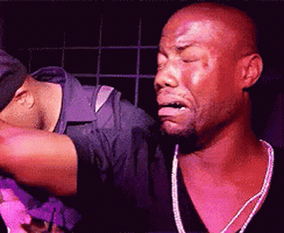 Two Men Are Standing Next To Each Other With One Making A Face GIF