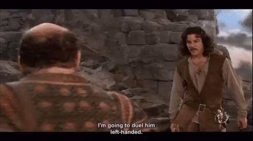 Two Men Are Standing Next To Each Other With One Saying I 'M Going To Duel Him Left Handed . GIF