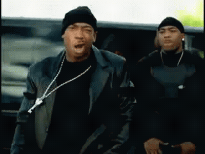 Two Men Are Standing Next To Each Other With One Wearing A Beanie And A Leather Jacket GIF