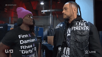 Two Men Are Standing Next To Each Other With One Wearing A Shirt That Says Finn And Damian GIF