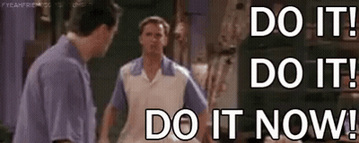 Two Men Are Standing Next To Each Other With The Words `` Do It ! Do It ! Do It Now ! '' . GIF