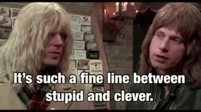 Two Men Are Standing Next To Each Other With The Words It 'S Such A Fine Line Between Stupid And Clever GIF